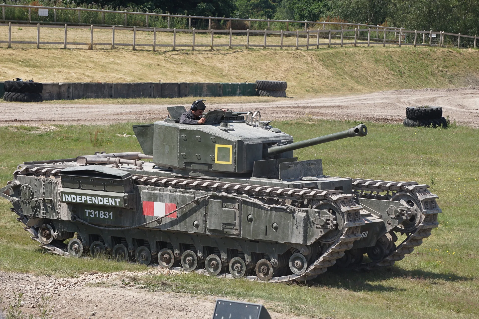 A Churchill tank named Independent, number T31831, standing on grass.